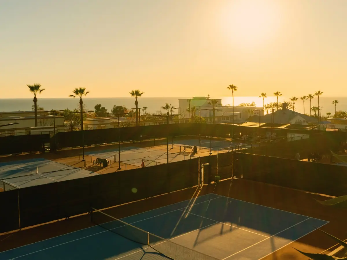 Laguna Beach Tennis Academy players training at sunset on coastal courts